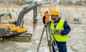 Surveyor marking site before construction - ALTA SURVEY Illinois Surveyor performing a construction survey to mark site layout before work begins